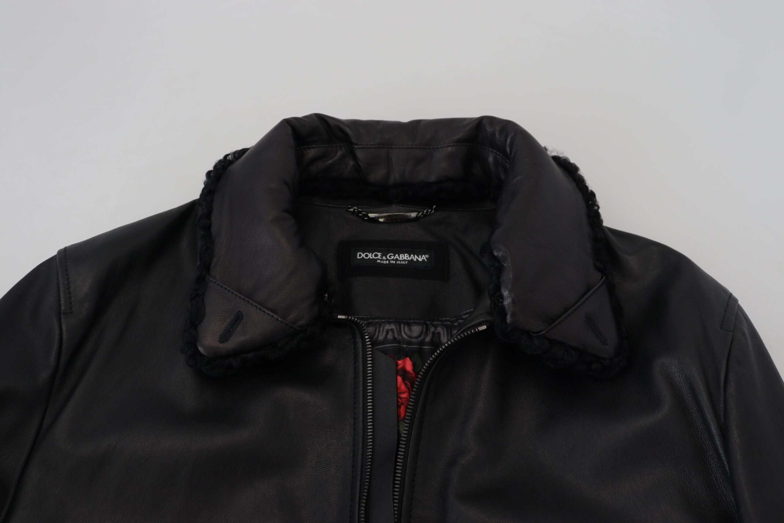 Black lamb leather men's coat with a collared design by Dolce & Gabbana, shown on a hanger.