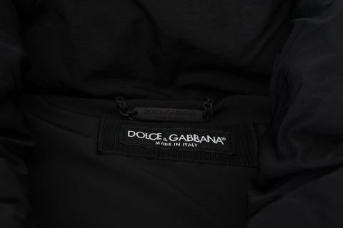 Black sleeveless Dolce & Gabbana jacket with metal embellishments, featuring a stylish sleeveless design and luxe detailing.
