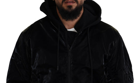 Black nylon hooded full zip bomber jacket by Dolce & Gabbana, shown on a hanger with front view and hood details.