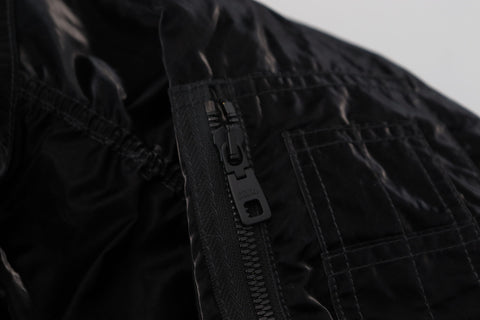 Black nylon hooded full zip bomber jacket by Dolce & Gabbana, shown with adjustable hood, front zipper, and ribbed cuffs.