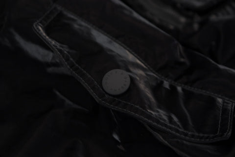 Black nylon hooded full-zip bomber jacket by Dolce & Gabbana, shown with front view and adjustable hood.
