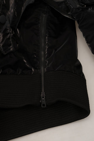 Black nylon hooded full zip bomber jacket by Dolce & Gabbana, featuring a sleek design and hooded collar.