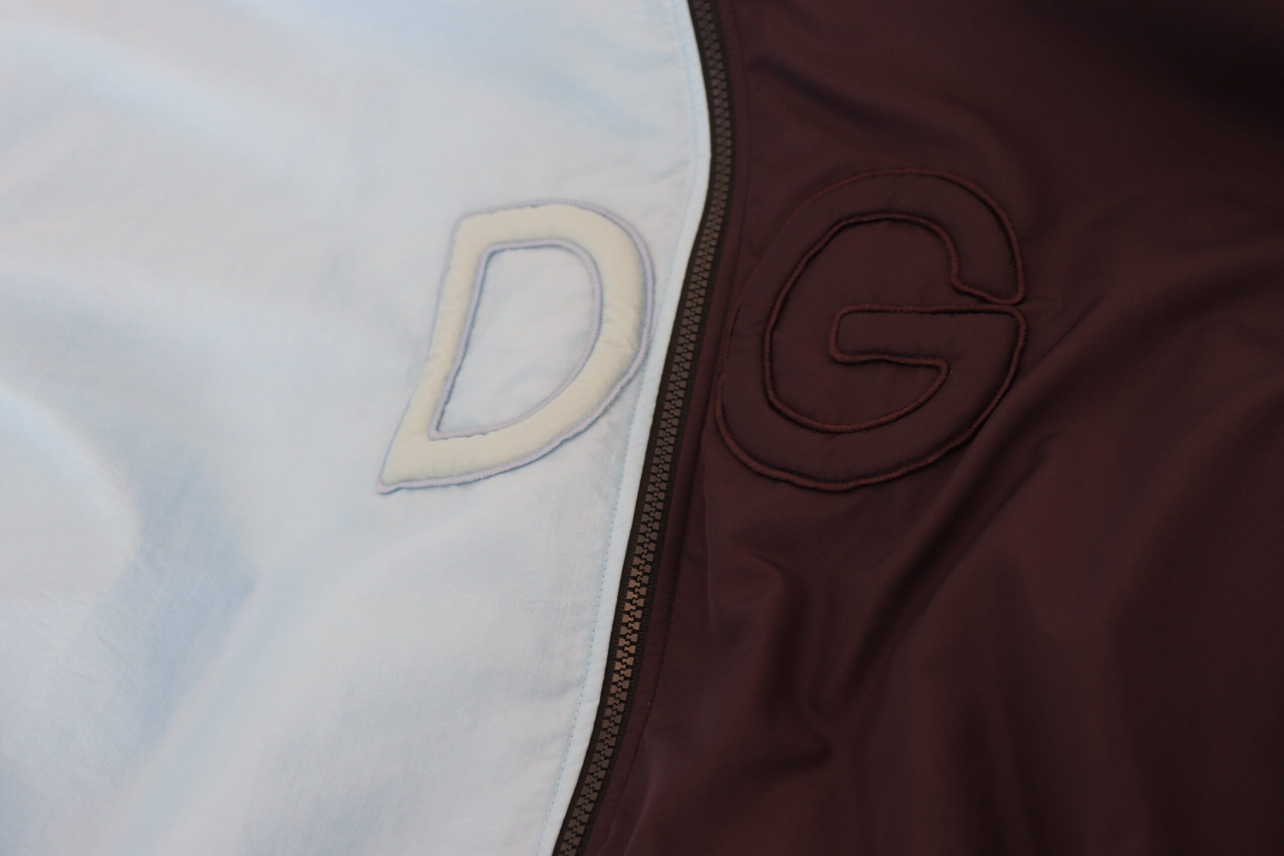 Black and blue Dolce & Gabbana hooded full-zip men's jacket with front pockets and stylish design.