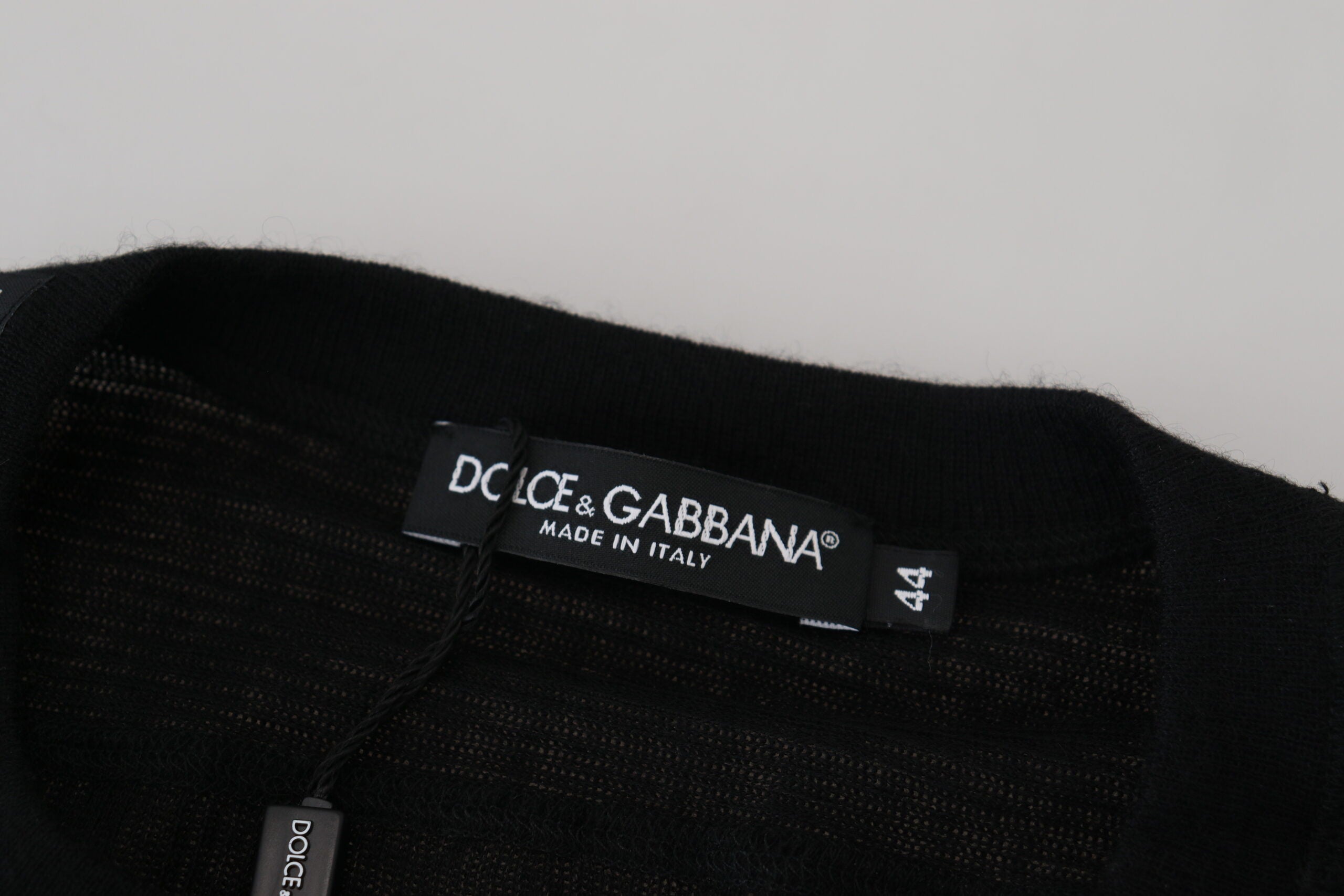 Black cashmere button pullover sweater by Dolce & Gabbana, featuring a classic crewneck and button details.