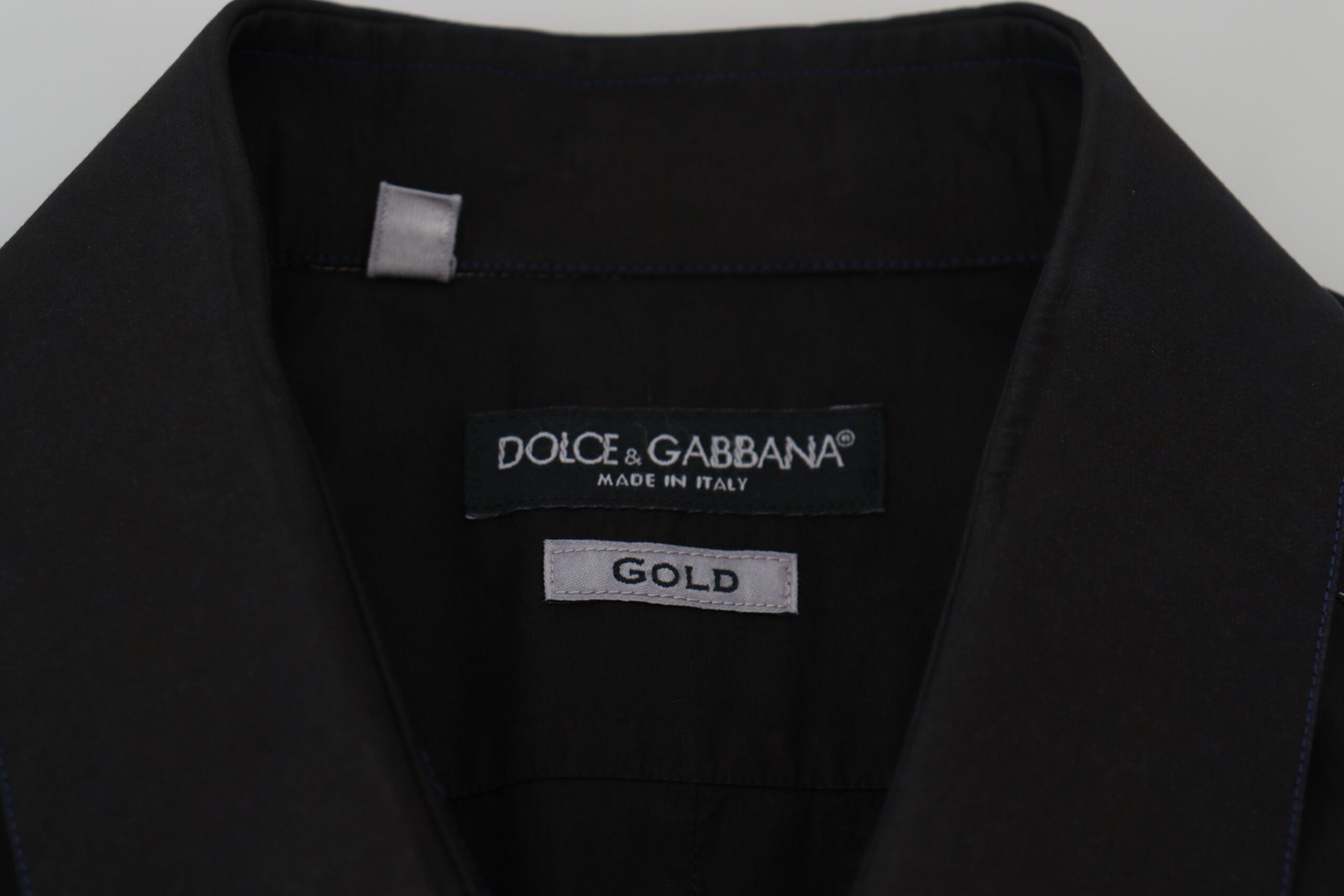 Black cotton long sleeve shirt with collar and gold accents by Dolce & Gabbana, shown with button details and tailored fit.