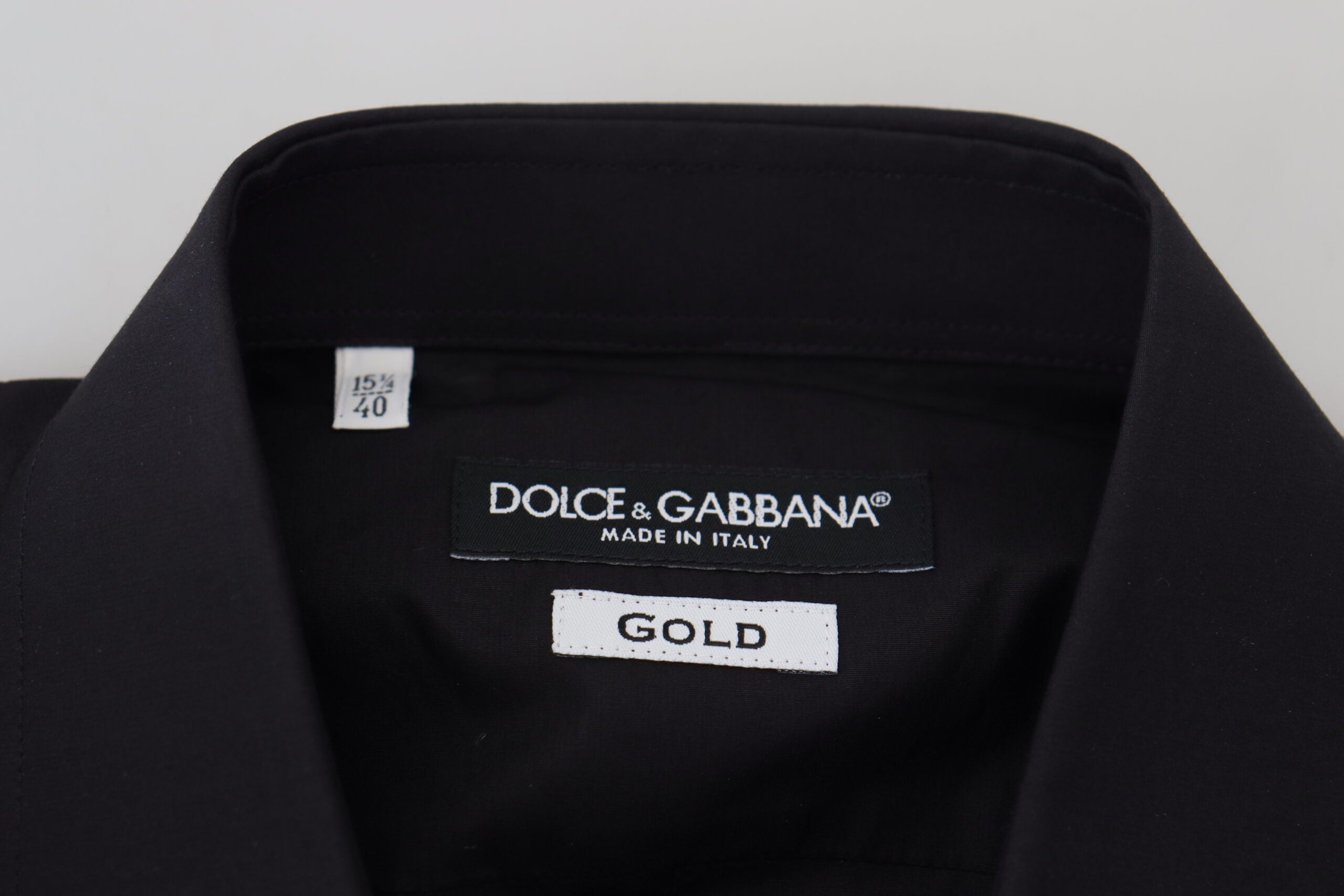 Black men's long sleeve shirt with gold floral embroidery by Dolce & Gabbana, featuring intricate floral designs on the fabric.