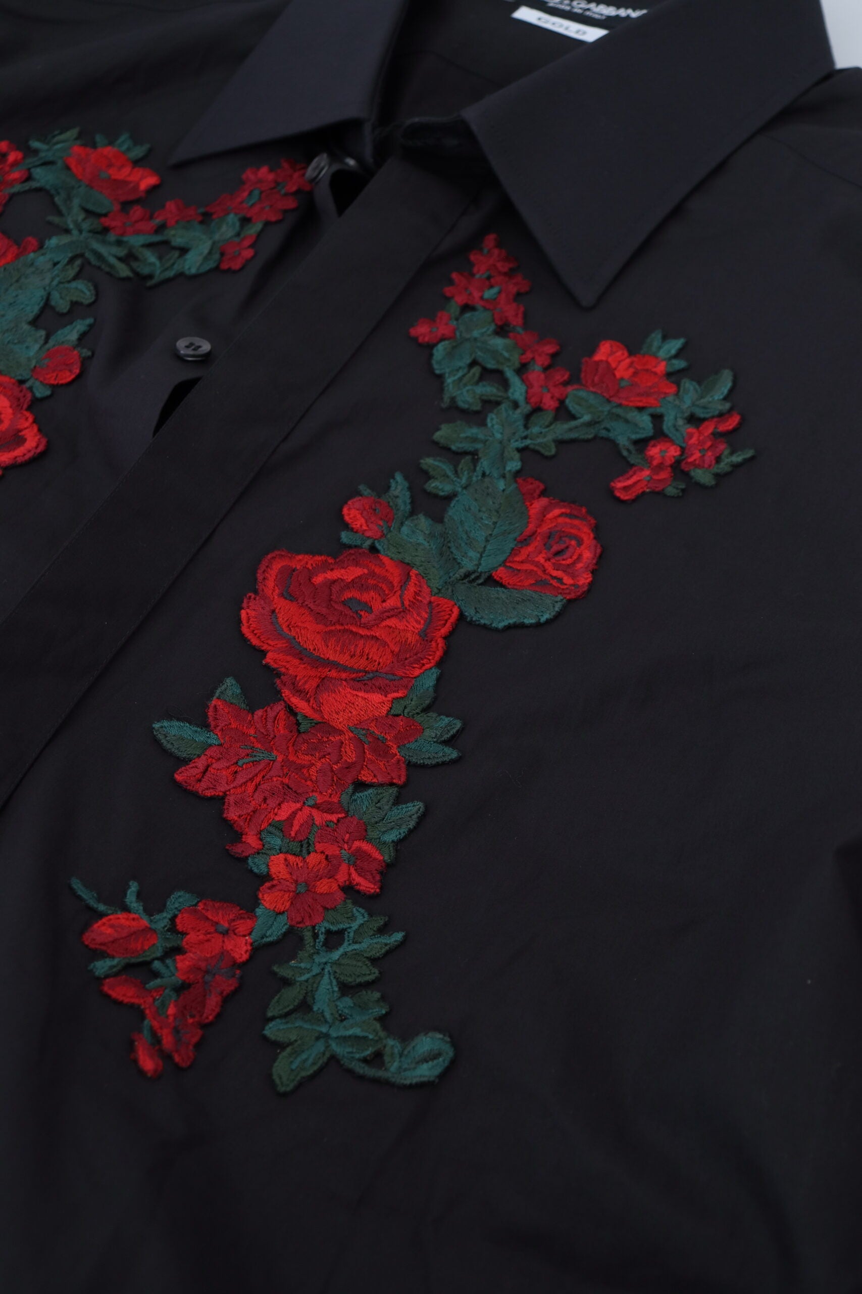 Black long sleeve men's shirt with gold floral embroidery by Dolce & Gabbana, featuring intricate floral embroidery on the front.