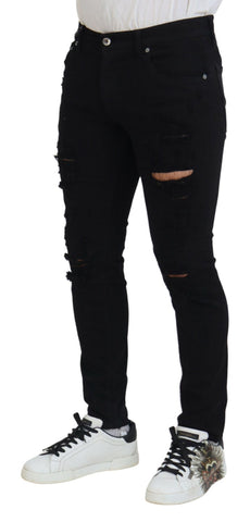 Black slim fit tattered denim cotton jeans by Dolce & Gabbana, featuring distressed details and modern style.