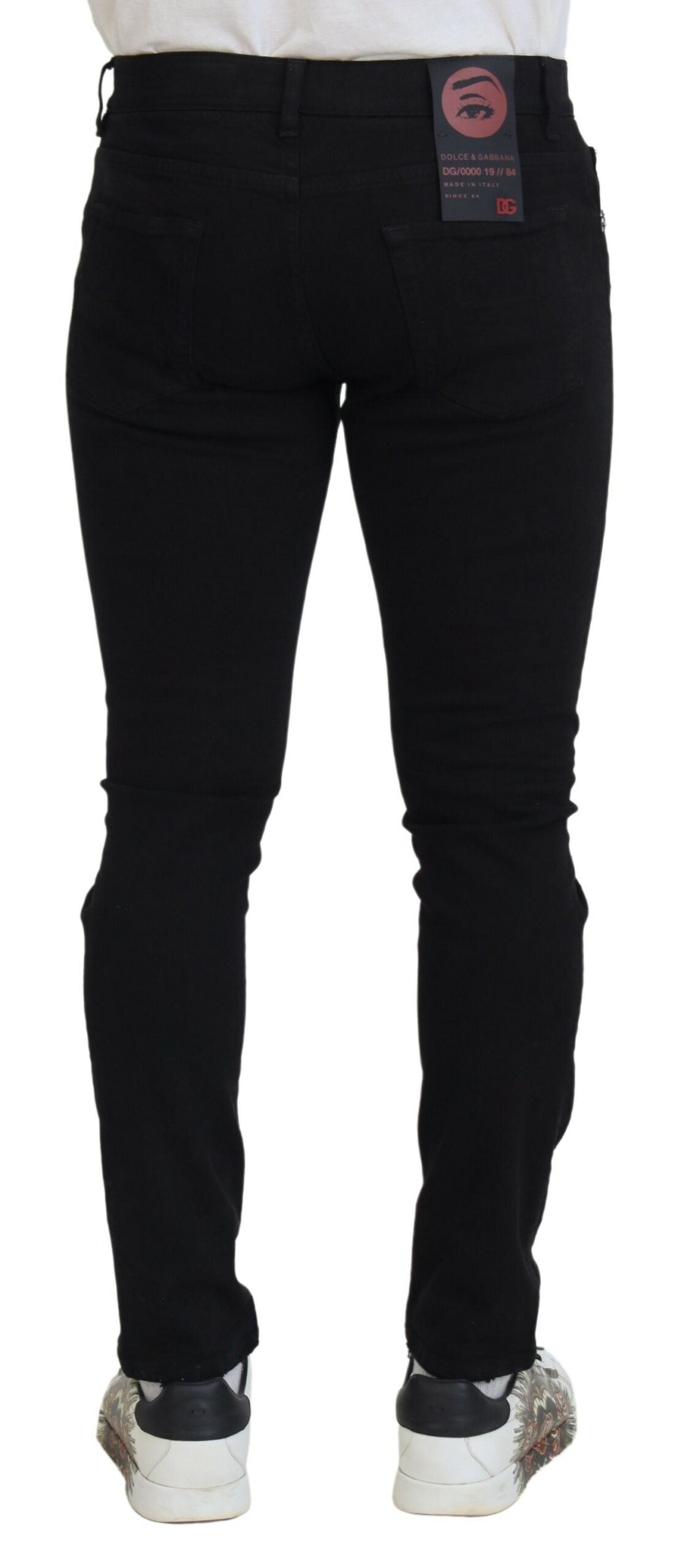 Black slim fit tattered denim cotton jeans by Dolce & Gabbana, showing distressed details and classic five-pocket design.