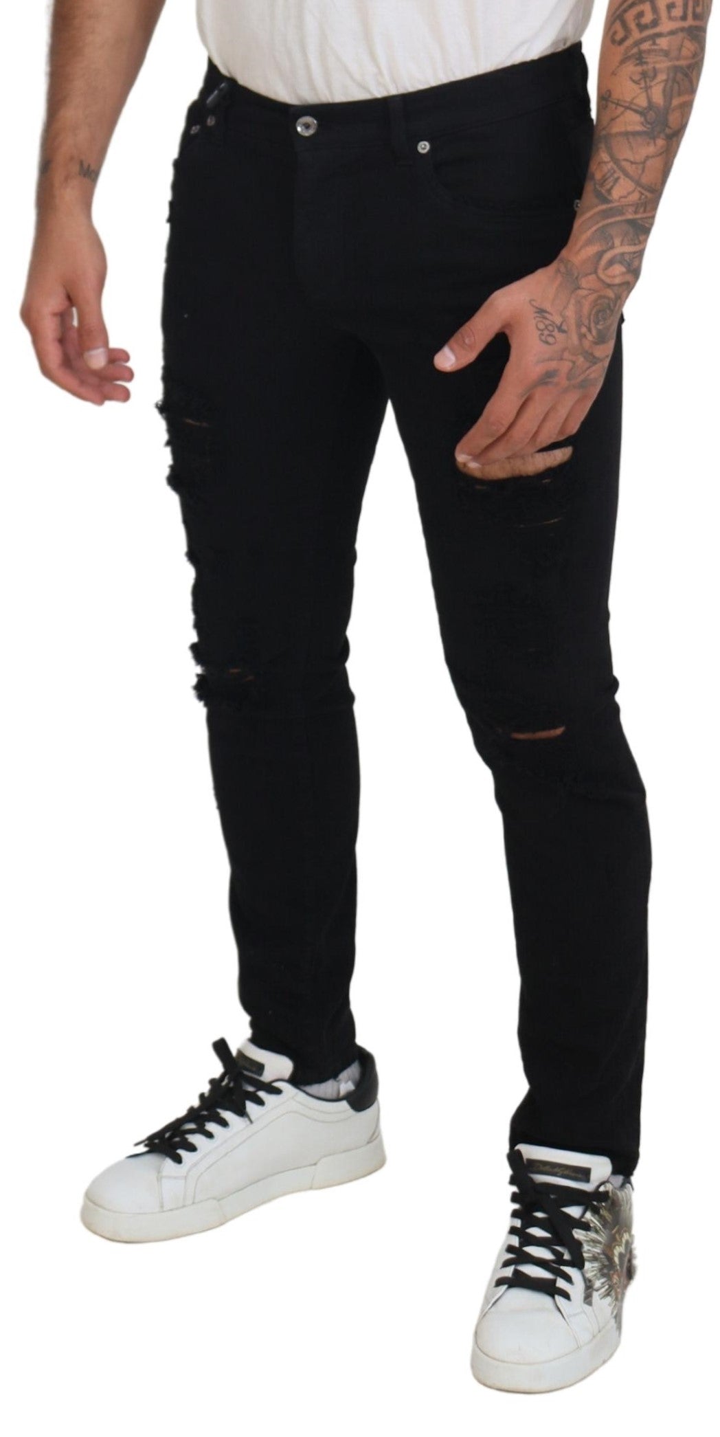 Black slim fit tattered denim cotton jeans by Dolce & Gabbana, showing distressed details and classic five-pocket design.