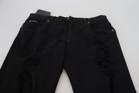 Black slim fit tattered denim cotton jeans by Dolce & Gabbana, shown with distressed details and classic five-pocket design.