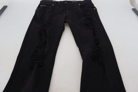 Black slim fit tattered denim cotton jeans by Dolce & Gabbana, showing distressed details and classic five-pocket design.