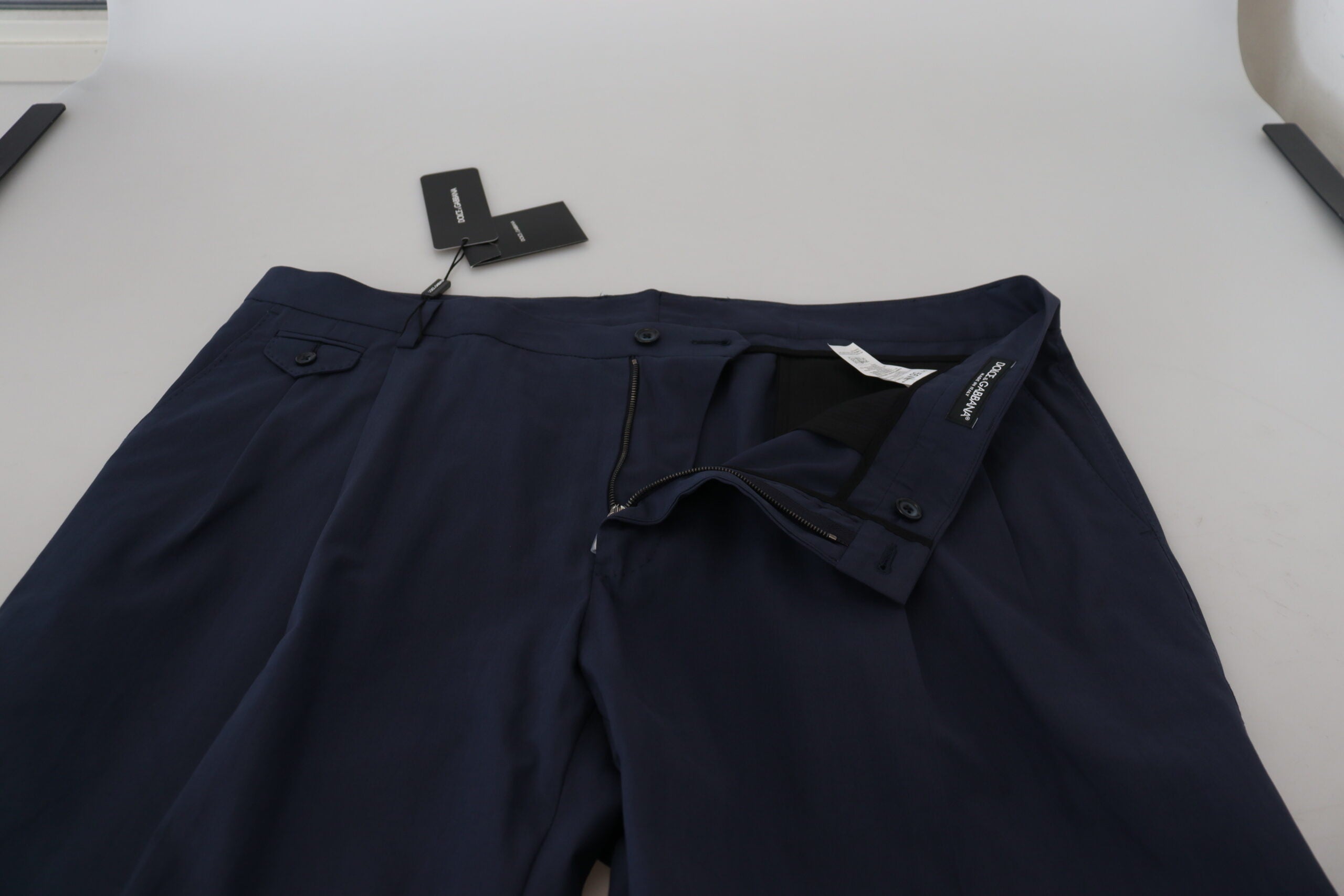 Dark blue cotton chino formal pants by Dolce & Gabbana, neatly folded with a smooth waistband and classic tailored fit.
