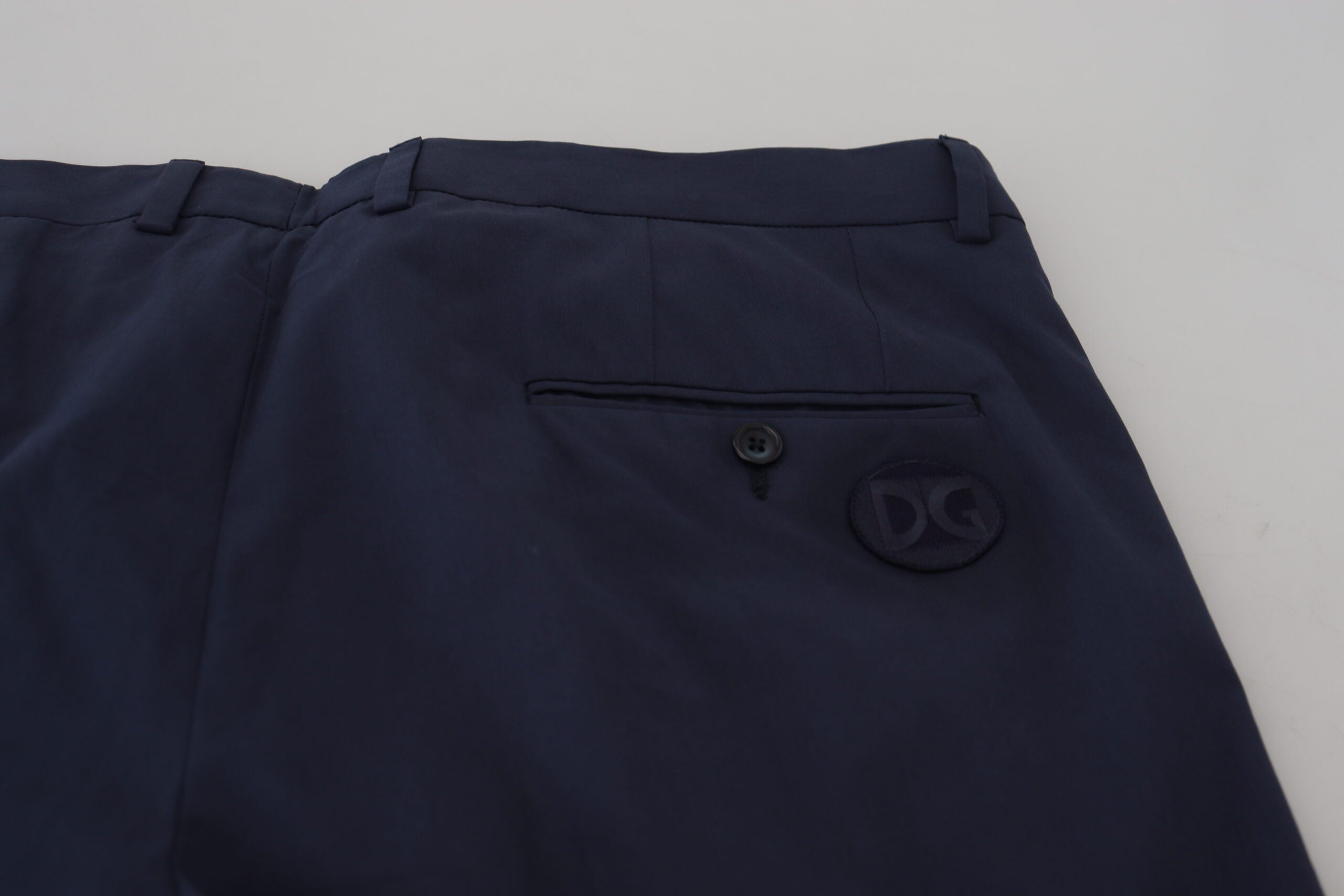 Dark blue cotton chino formal pants by Dolce & Gabbana, tailored fit with classic style, shown on a hanger.