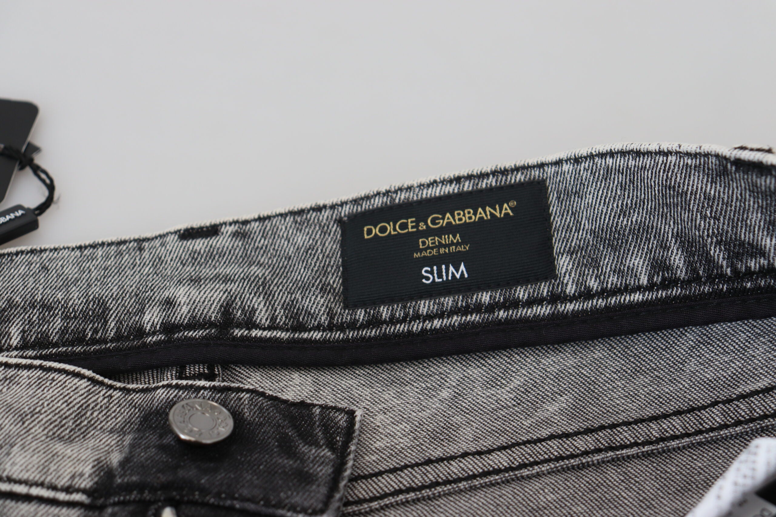 Grey washed cotton slim fit men's denim jeans by Dolce & Gabbana, showing front with pockets and belt loops.
