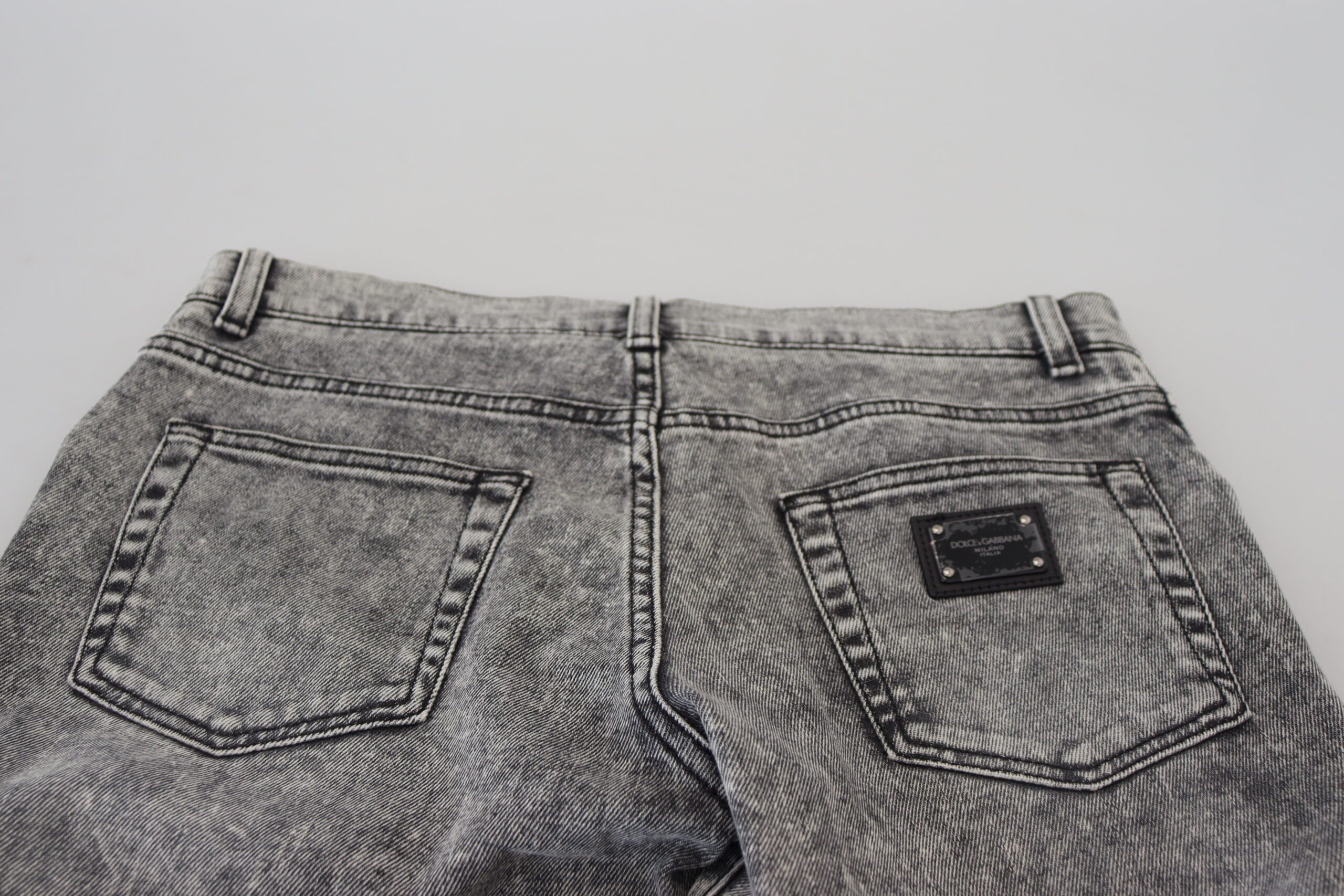 Grey washed cotton slim fit men's denim jeans by Dolce & Gabbana, showcasing a close-up of the fabric and fit.