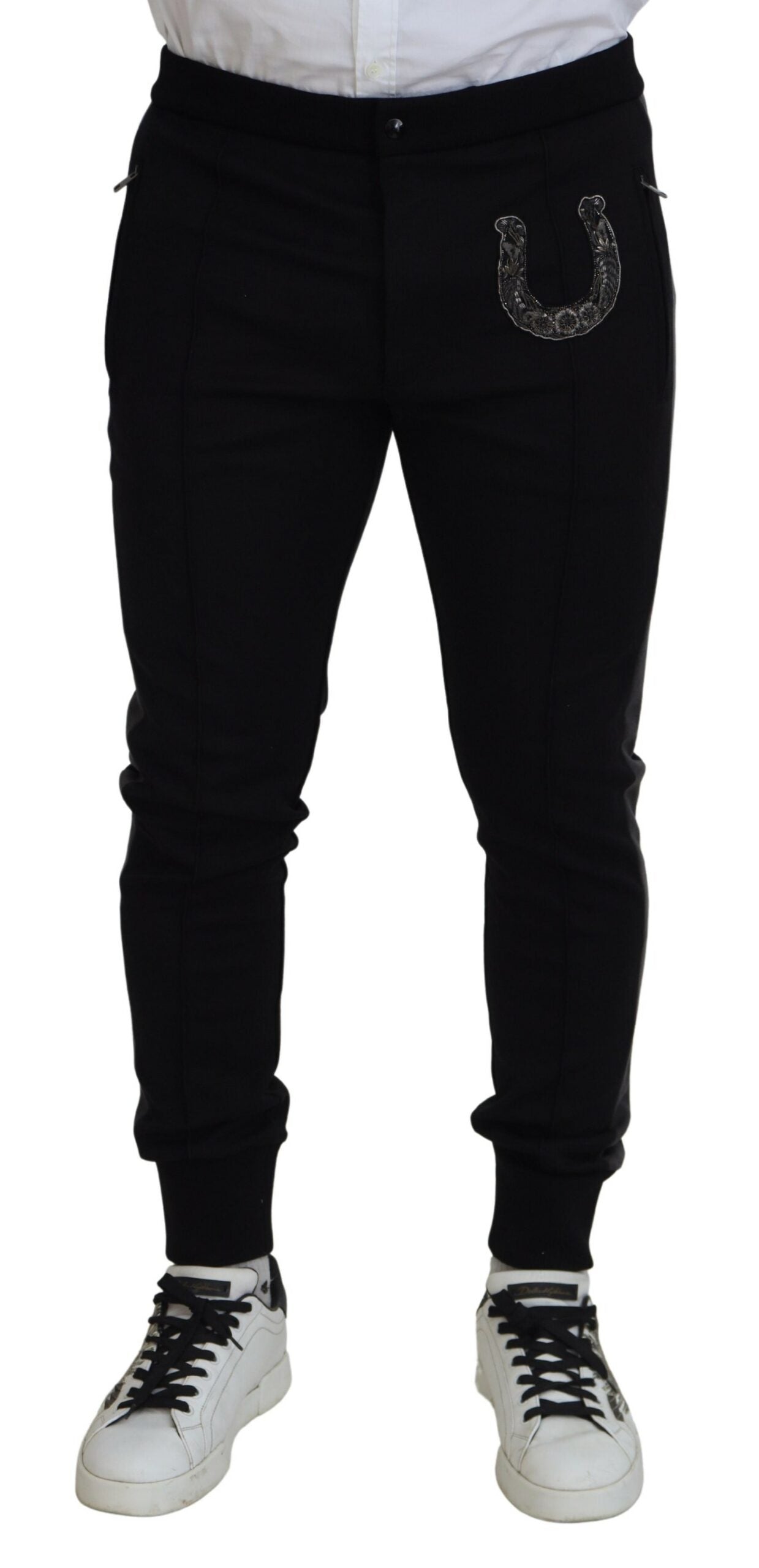 Black wool horseshoe jogger pants by Dolce & Gabbana, showing a relaxed fit with elastic waistband and horseshoe detailing.