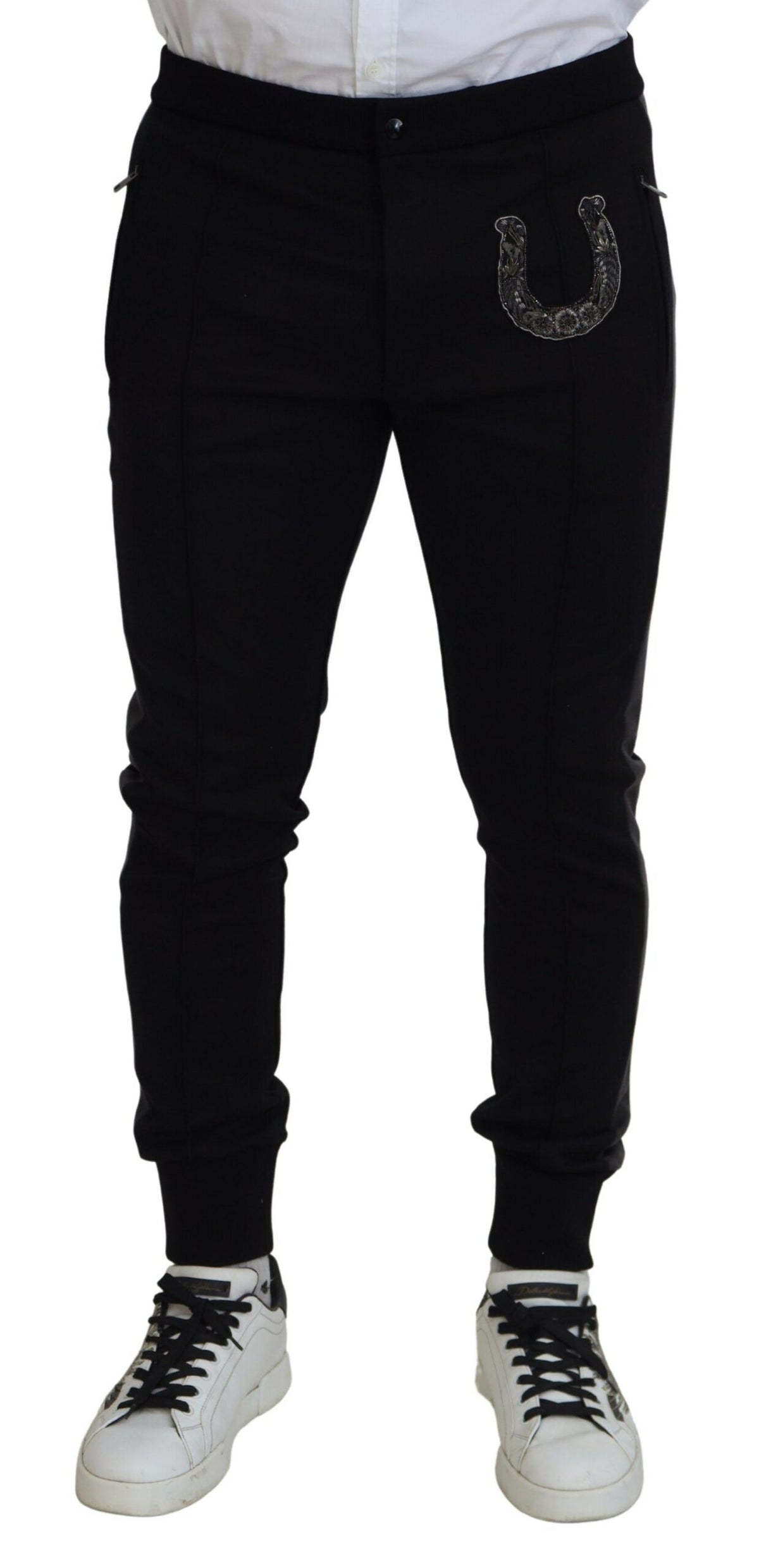 Black wool horseshoe jogger pants by Dolce & Gabbana, showing a relaxed fit with elastic waistband and horseshoe detailing.