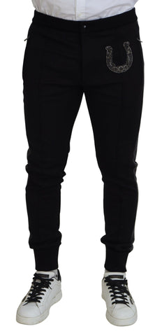 Black wool horseshoe jogger pants by Dolce & Gabbana, showing a relaxed fit with elastic waistband and horseshoe detailing.