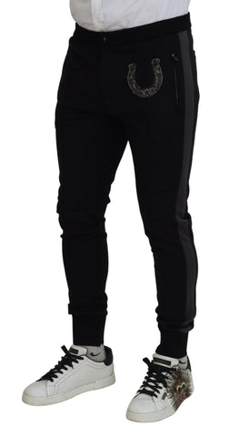 Black wool horseshoe jogger pants by Dolce & Gabbana, featuring a relaxed fit and elastic waistband on a model.