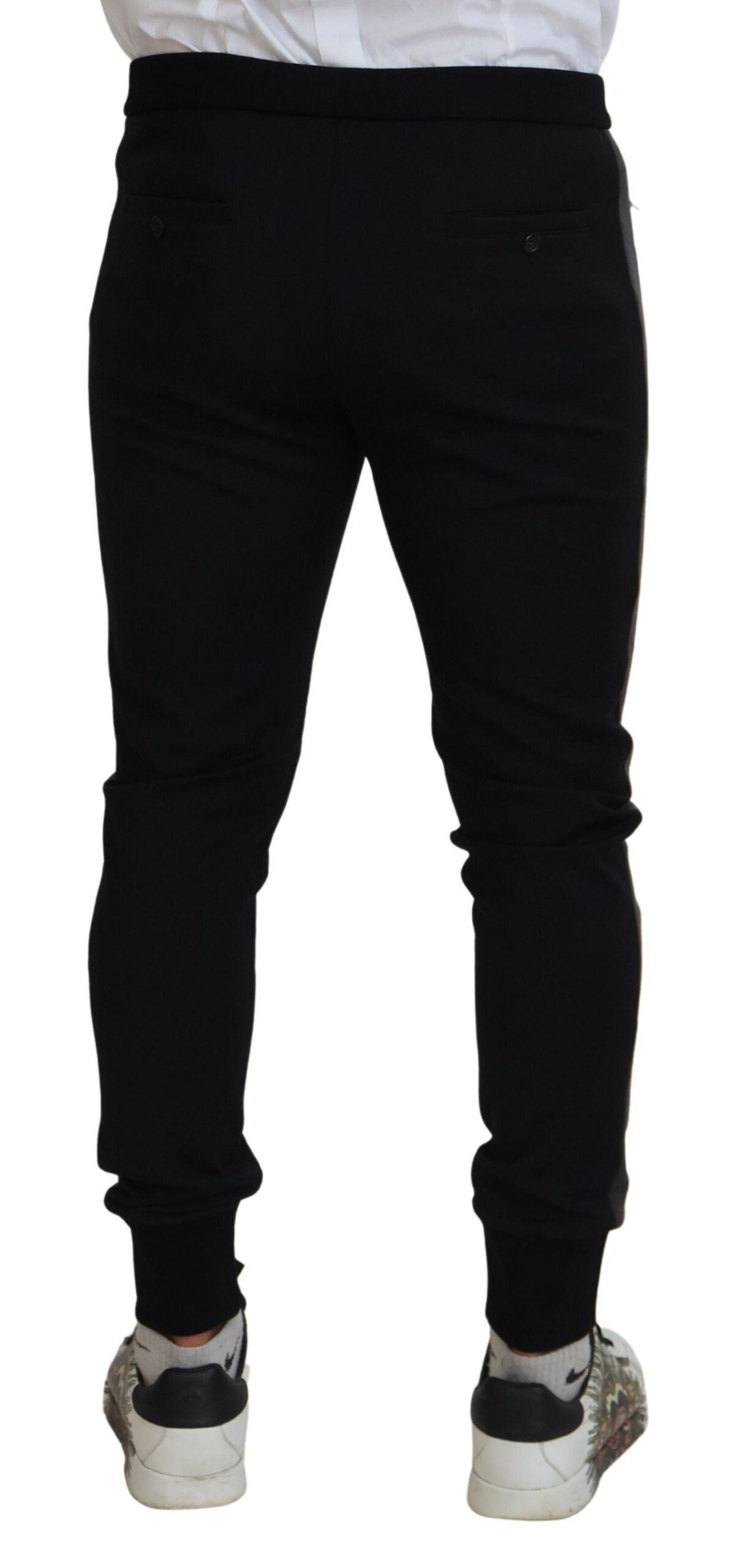 Black wool horseshoe jogger pants by Dolce & Gabbana, shown with elastic waistband and tapered fit, on a neutral background.