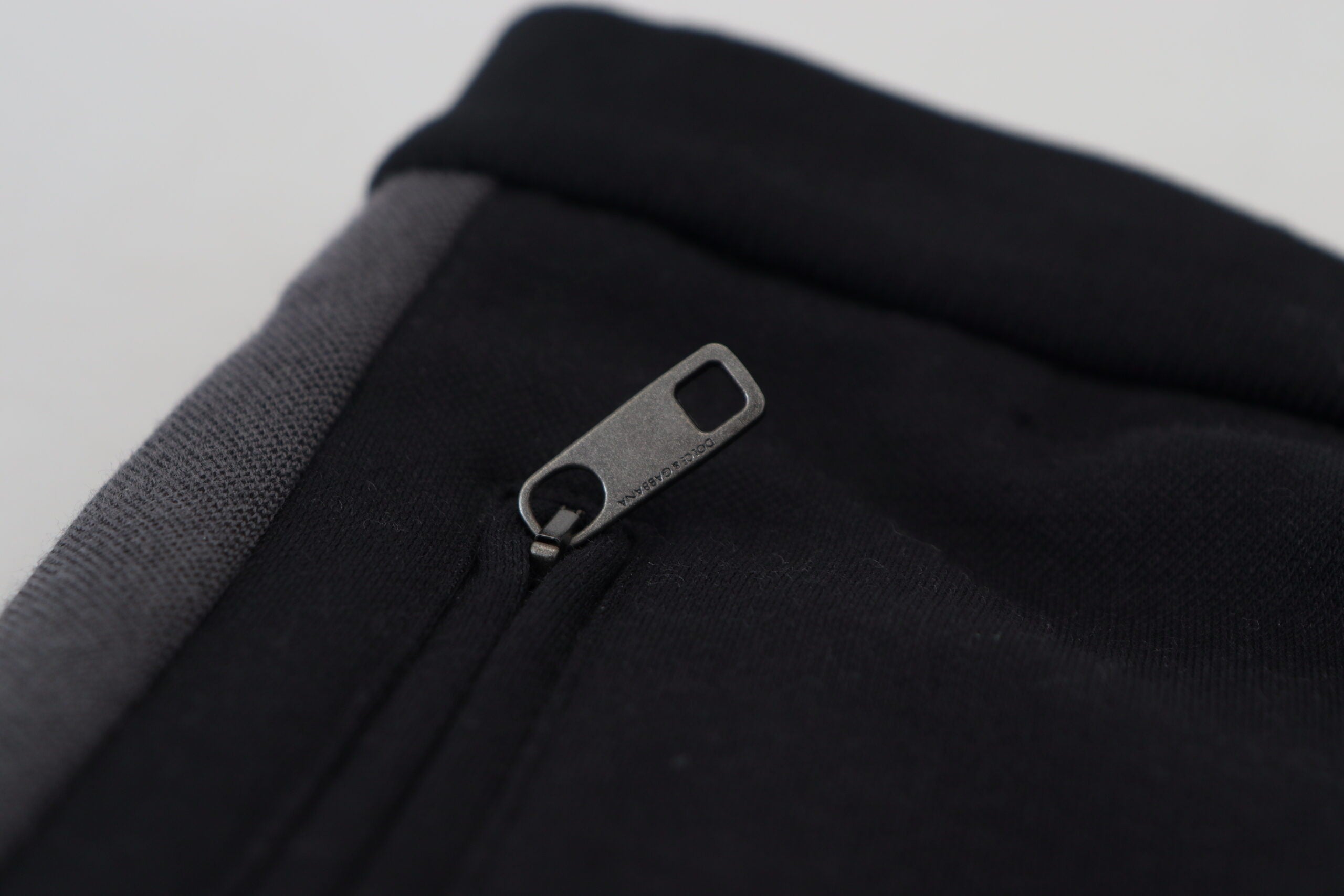 Black wool horseshoe jogger pants by Dolce & Gabbana, featuring a relaxed fit and stylish design, front view showing waistband and pockets.
