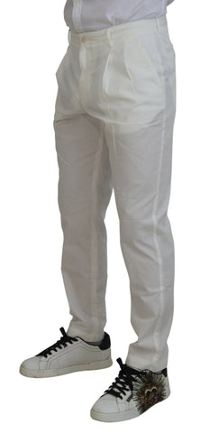 White cotton skinny chino pants by Dolce & Gabbana, shown on a model with a close-up view of the fit and fabric details.