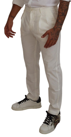 White cotton skinny chino pants by Dolce & Gabbana, shown on a model, featuring a slim fit and classic design.