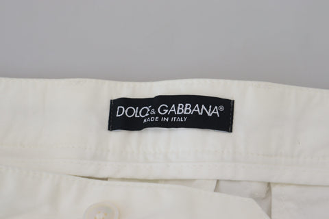 White cotton skinny chino pants by Dolce & Gabbana displayed on a model, showcasing slim fit and classic design.