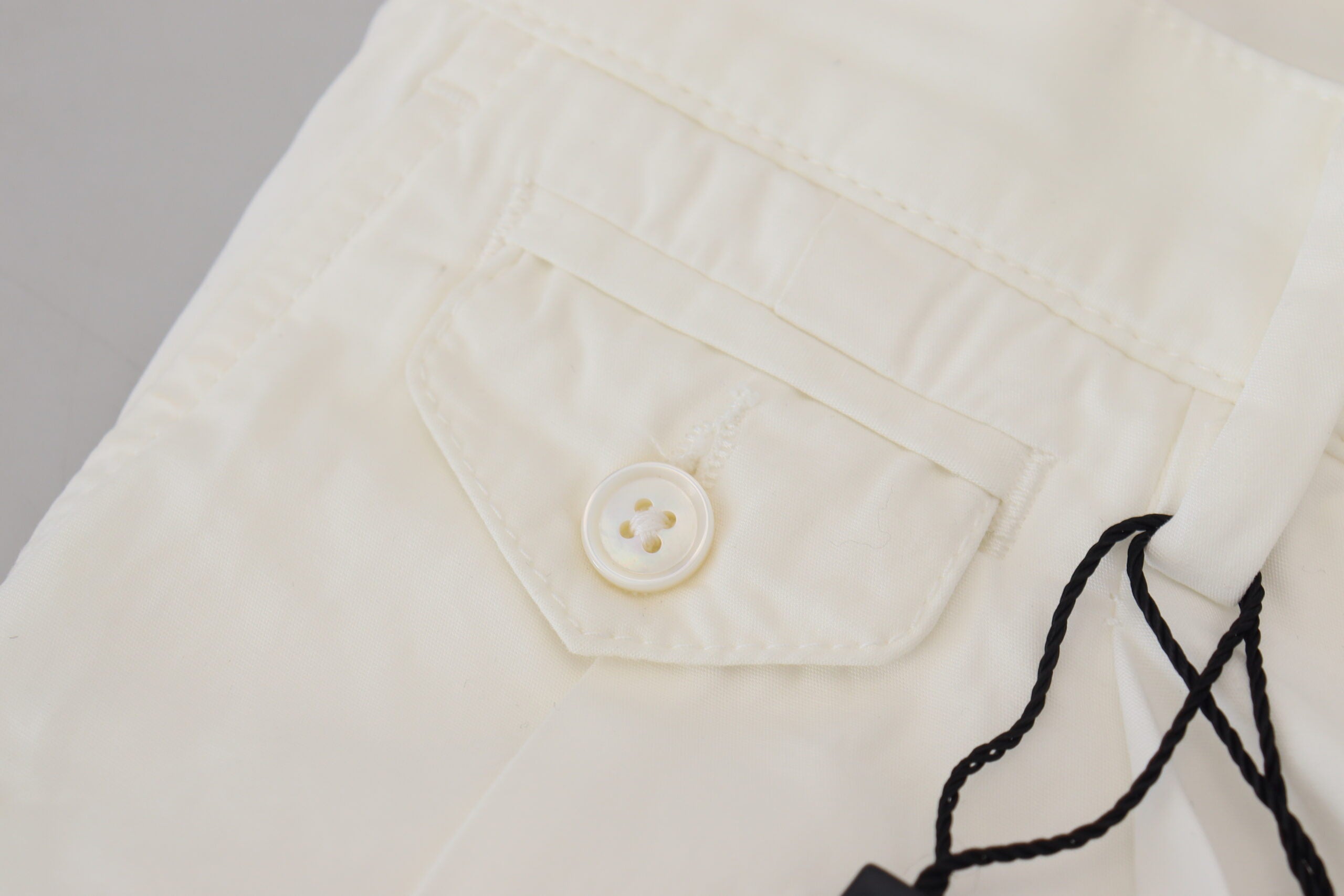 White cotton skinny chino pants by Dolce & Gabbana, shown on a model, featuring a slim fit and classic chino style.