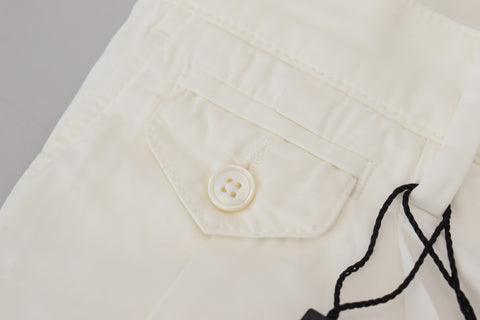 White cotton skinny chino pants by Dolce & Gabbana, shown on a model, featuring a slim fit and classic chino style.