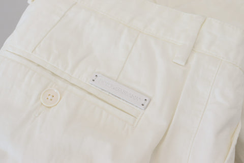White cotton skinny chino pants by Dolce & Gabbana, shown on a model with a close-up view of the fitted design and clean fabric.