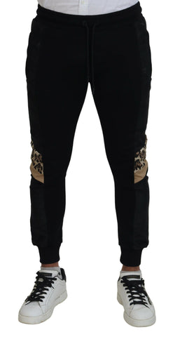 Black polyester skinny jogger pants for men by Dolce & Gabbana, featuring a slim fit and tapered design.