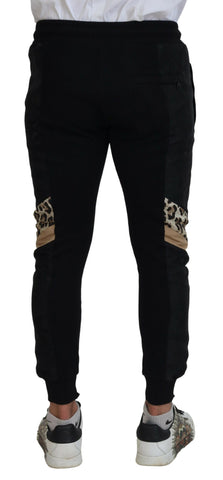 Black polyester skinny jogger pants for men by Dolce & Gabbana, showing fitted style and elastic waistband.