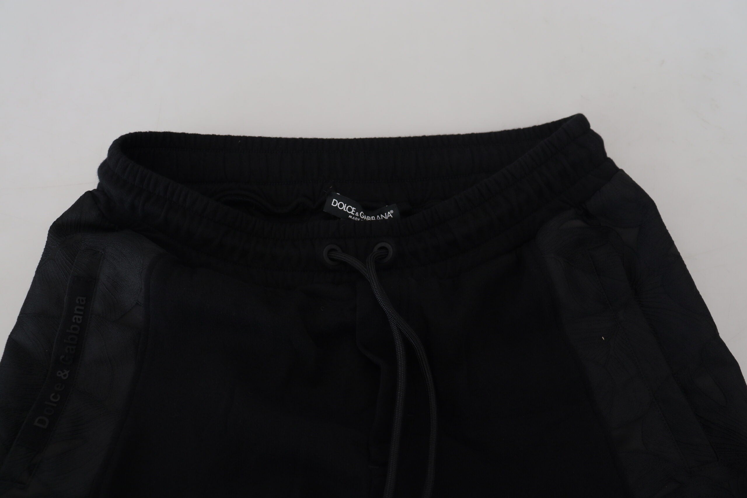 Black polyester skinny jogger pants for men by Dolce & Gabbana, shown with elastic waistband and tapered fit.