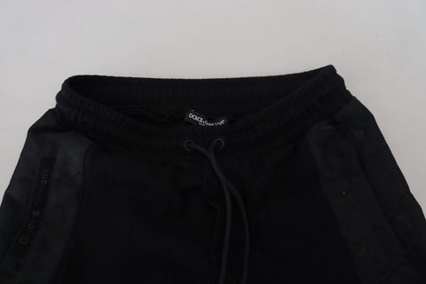 Black polyester skinny jogger pants for men by Dolce & Gabbana, shown with elastic waistband and tapered fit.