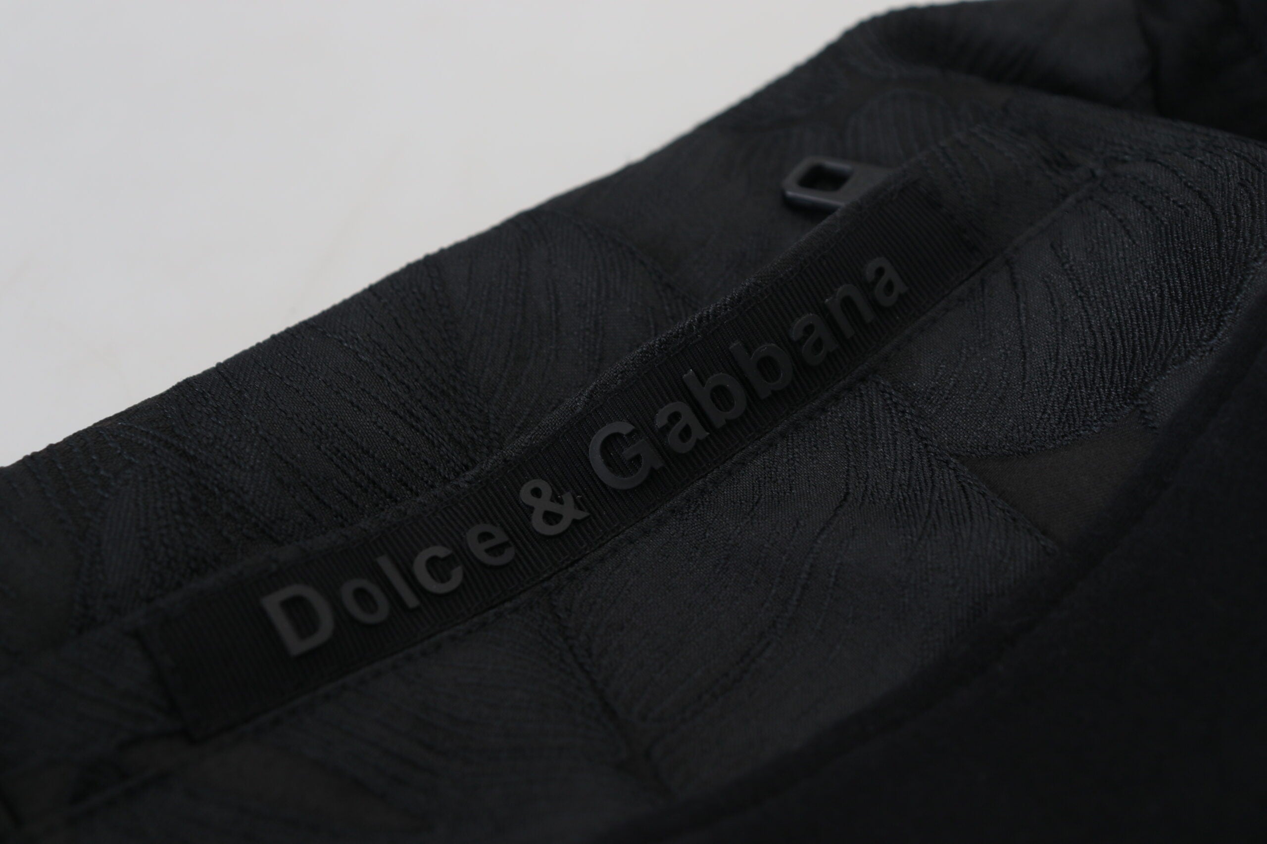 Black polyester skinny jogger pants for men by Dolce & Gabbana, featuring a tapered fit and elastic waistband.