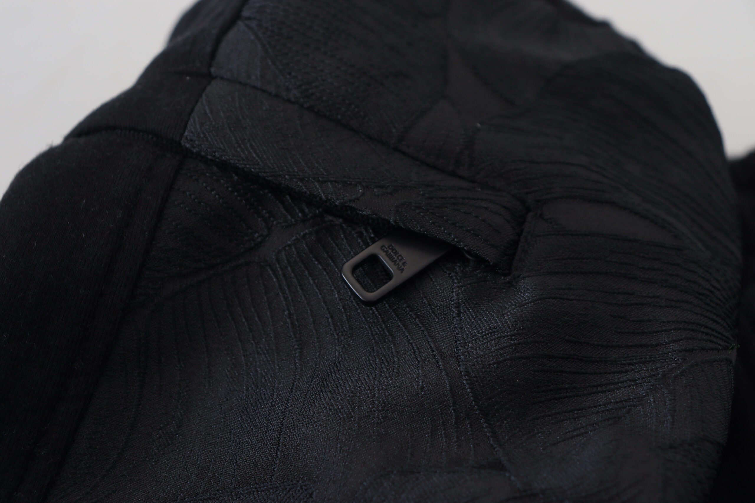 Black polyester skinny jogger pants for men by Dolce & Gabbana, featuring a slim fit design and elastic waistband.