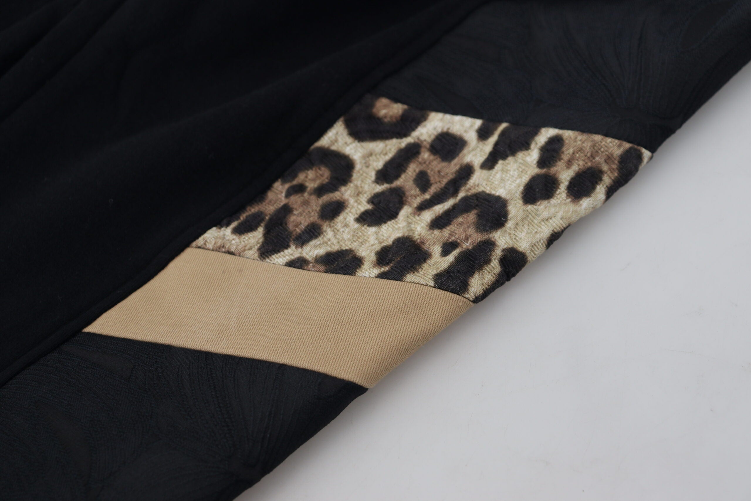 Black polyester skinny jogger men's pants by Dolce & Gabbana, showing close-up of fitted waist and tapered leg design.
