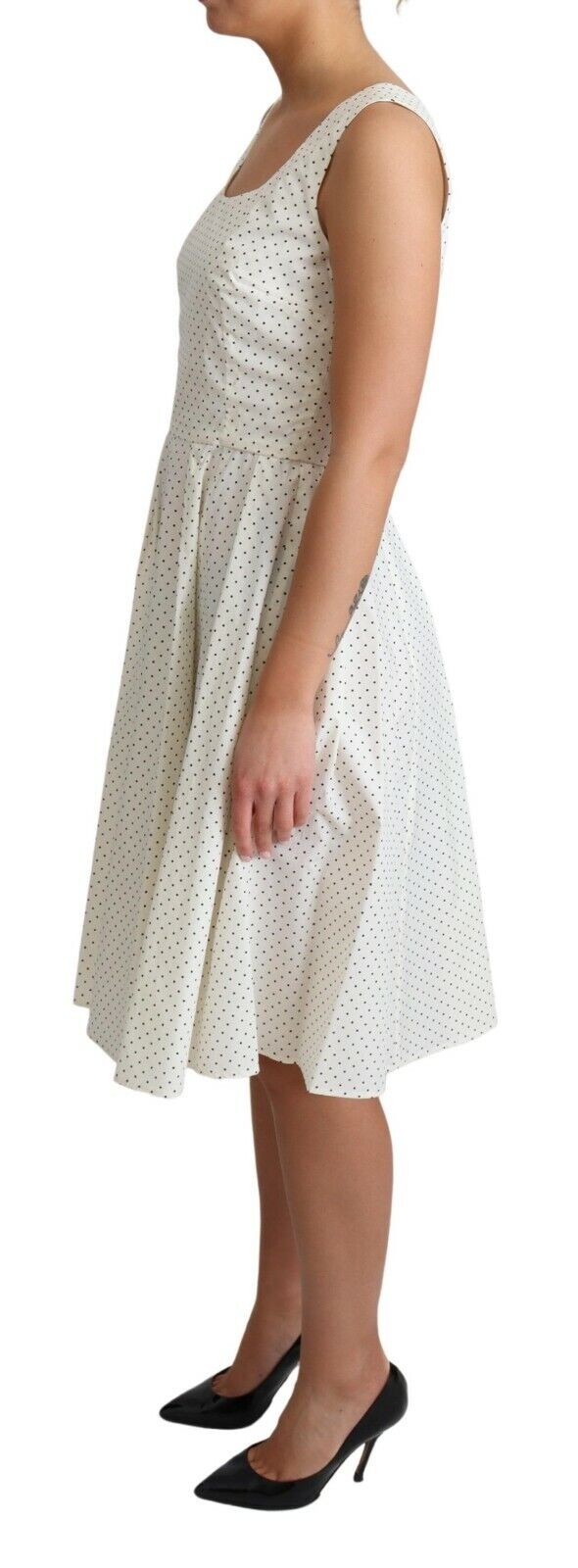 White cotton A-line dress with black polka dots from Dolce & Gabbana, featuring a sleeveless design and classic feminine style.