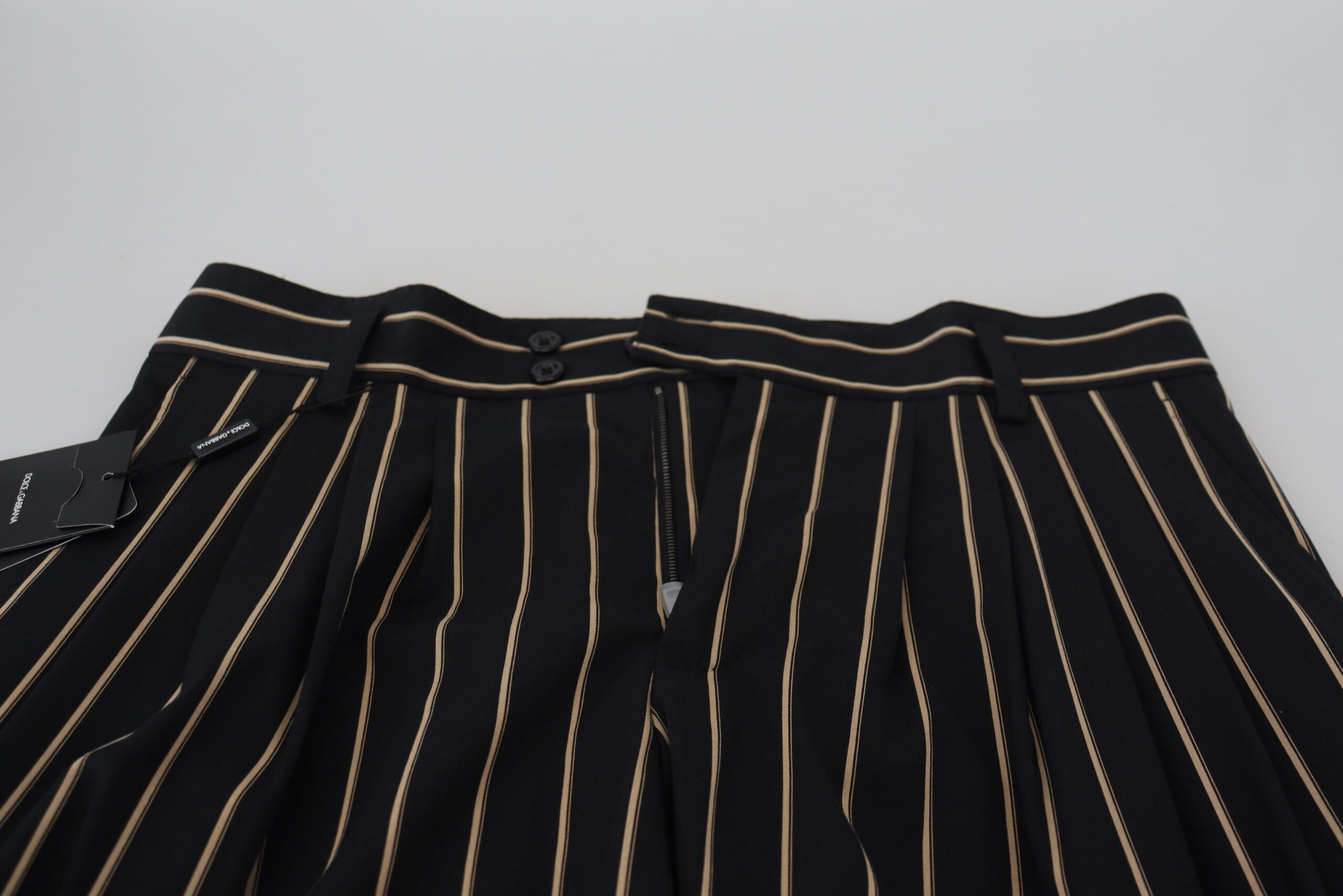 Black and beige striped cotton stretch pants by Dolce & Gabbana, showing tailored fit and bold striped pattern.
