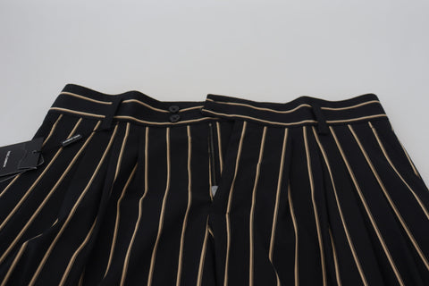 Black and beige striped cotton stretch pants by Dolce & Gabbana, showing tailored fit and bold striped pattern.