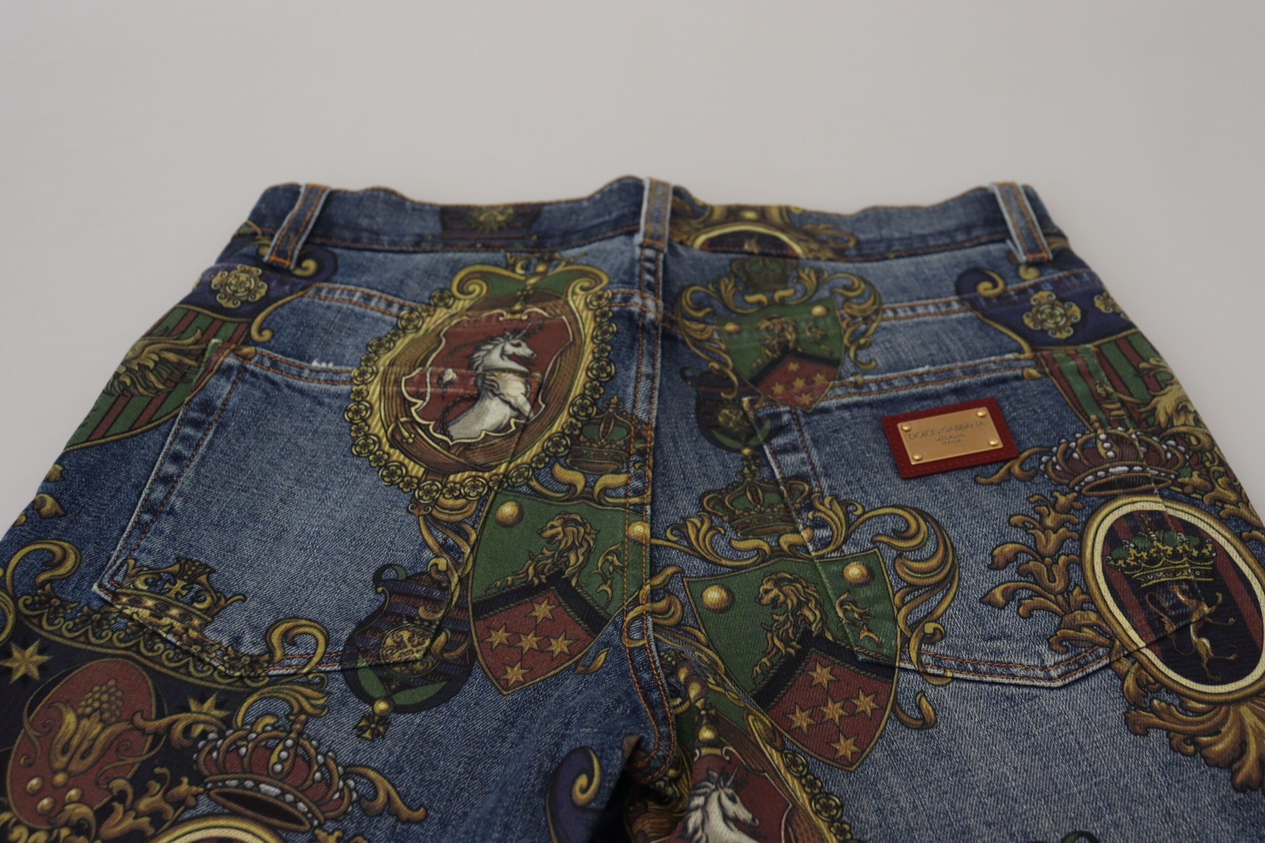 Blue Medal Print Slim Fit Cotton Jeans by Dolce & Gabbana, shown on a model with front and back details.