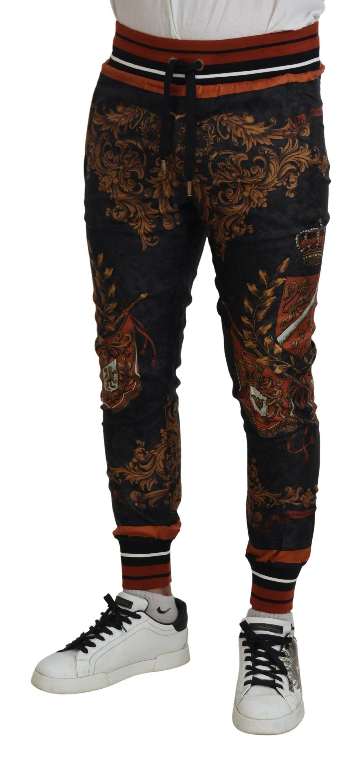 Gray silk Baroque crown trousers by Dolce & Gabbana, featuring luxurious fabric and ornate design, styled as sport pants.