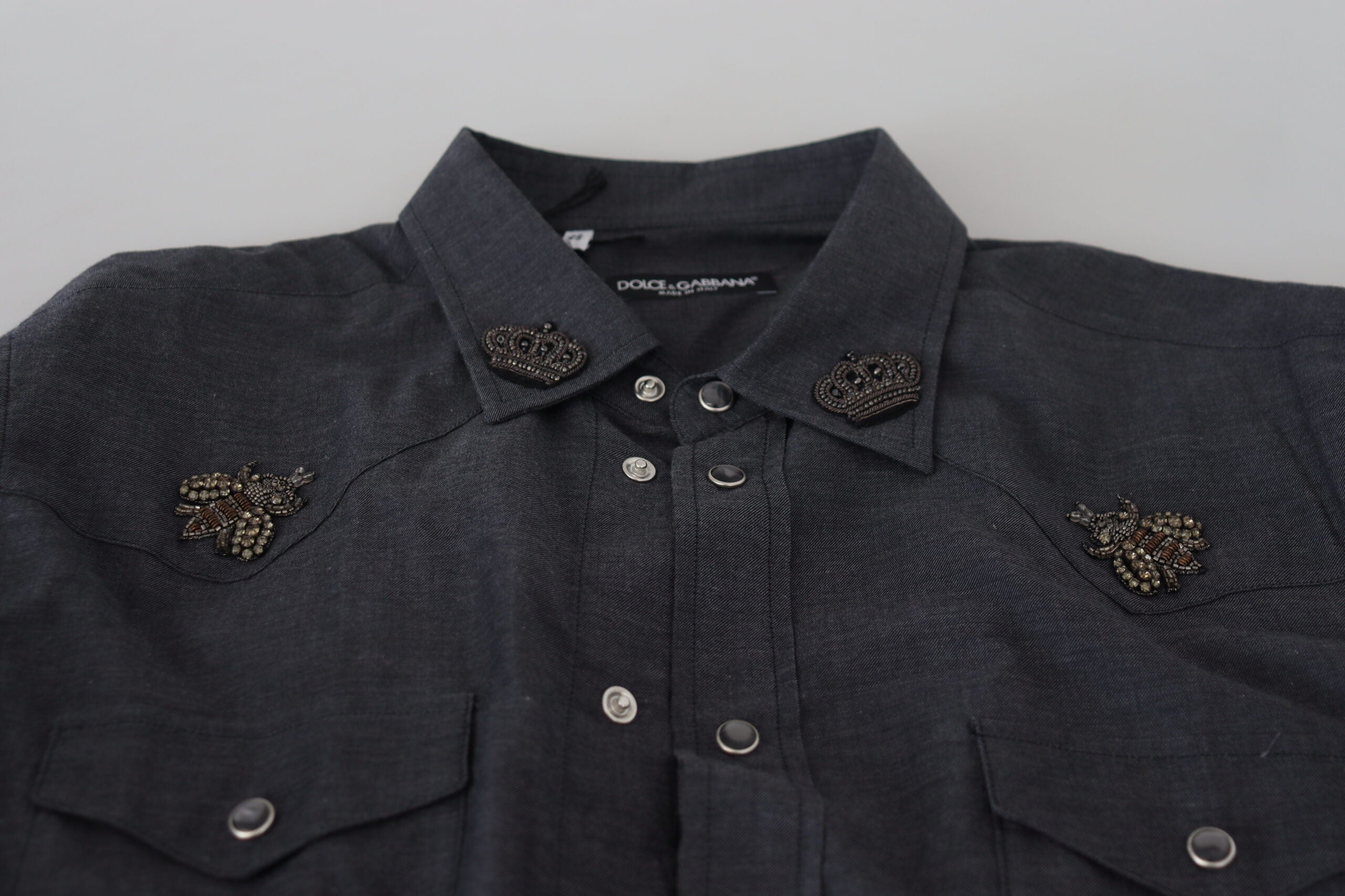 Blue cotton denim shirt by Dolce & Gabbana with crystal bee embroidery and button-down front, casual and stylish for everyday wear.