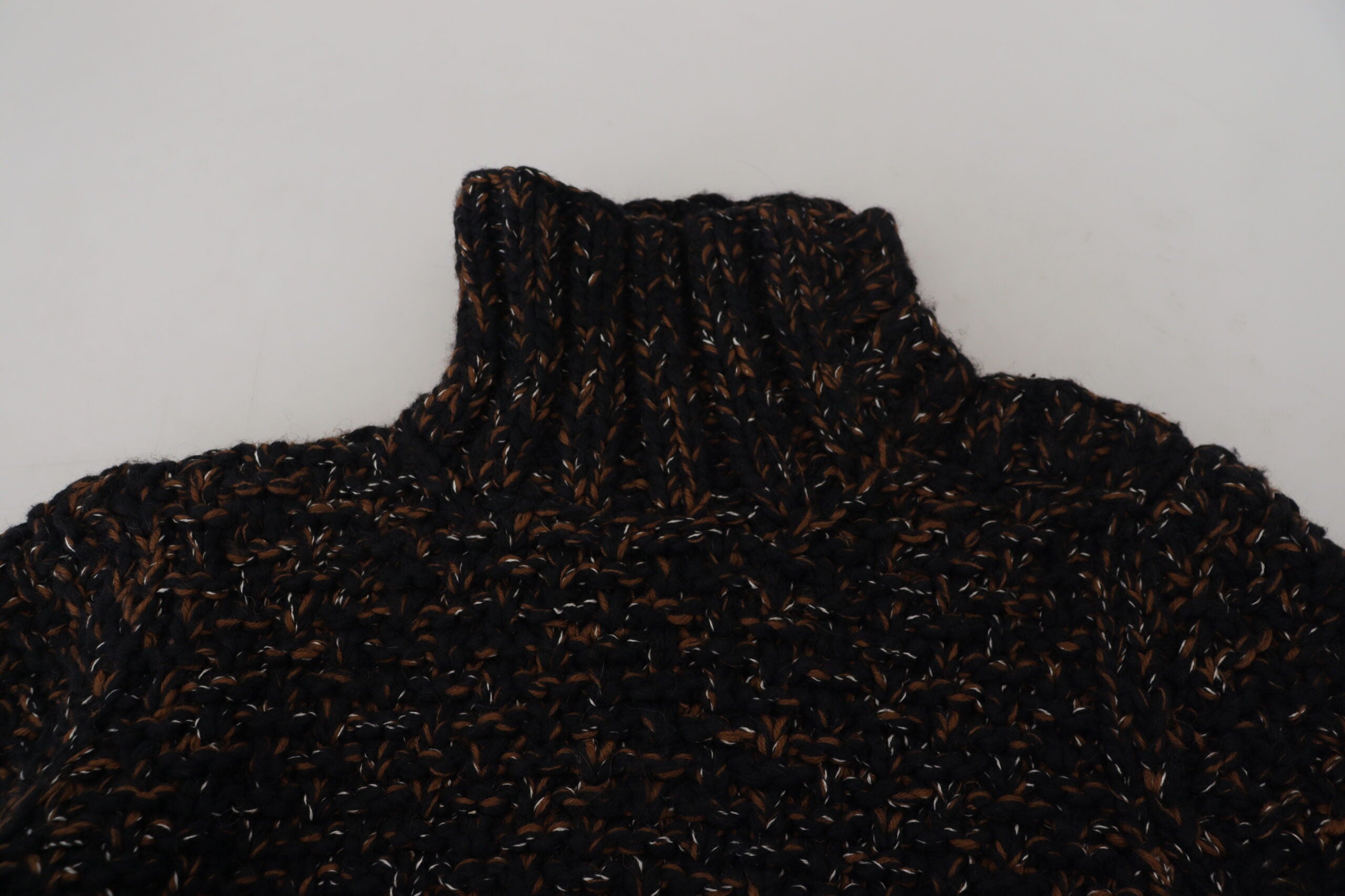 Brown Dolce & Gabbana Fatto A Mano turtleneck sweater, close-up of textured knit fabric and ribbed collar detail.