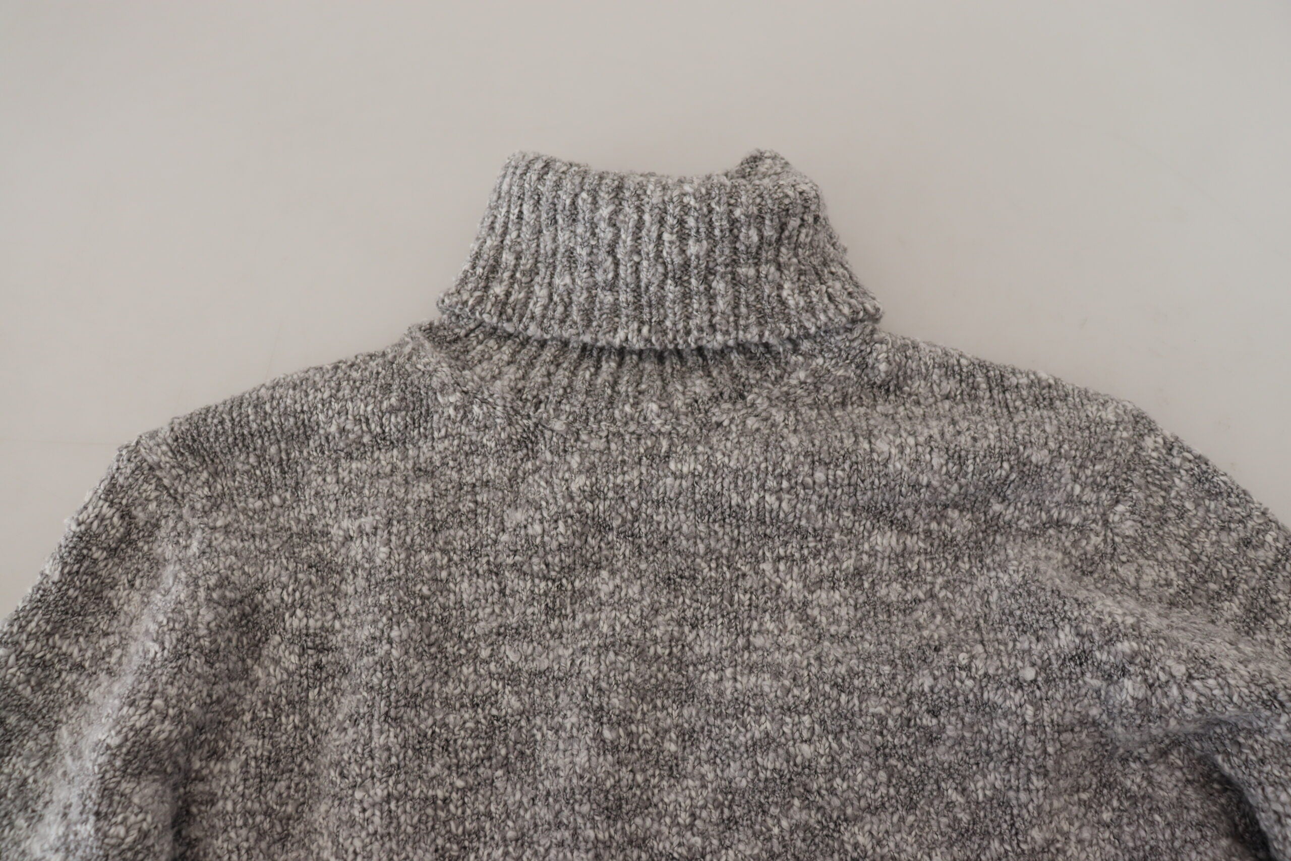 Gray wool knit turtleneck sweater by Dolce & Gabbana, close-up view of the cozy, textured knit fabric and high neckline.