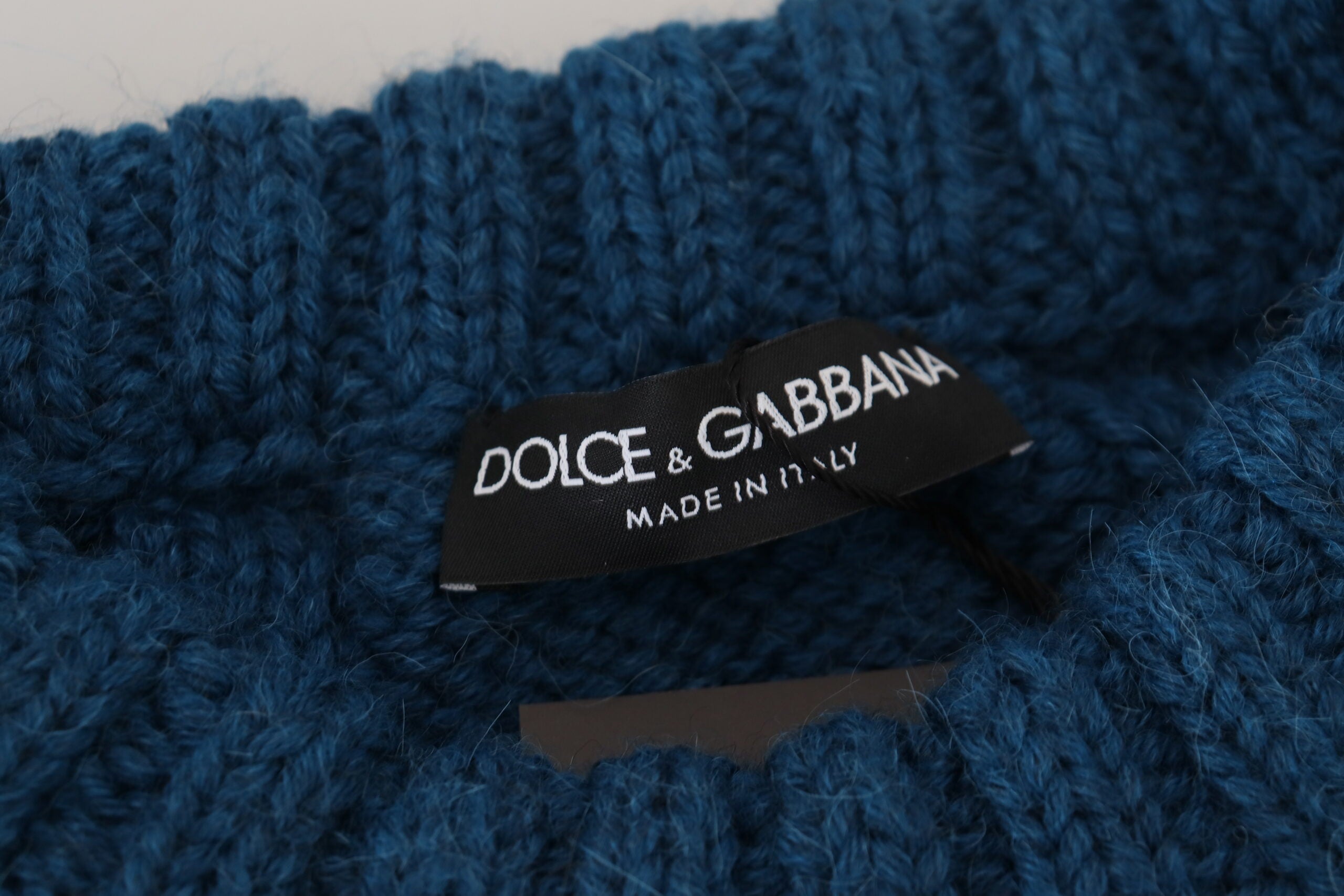 Blue knitted wool alpaca pullover sweater by Dolce & Gabbana, showing close-up of textured knit fabric and classic fit.