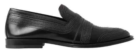 Black leather slipper loafers with stitched detailing from Dolce & Gabbana, showcasing a sleek, classic shoe design.