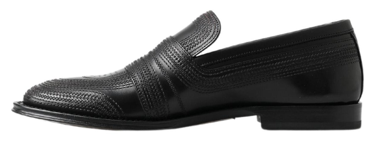 Black leather slipper loafers with stitched detailing from Dolce & Gabbana, featuring a sleek slip-on design and polished finish.